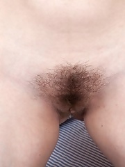 Beata strips naked in bed wearing stockings