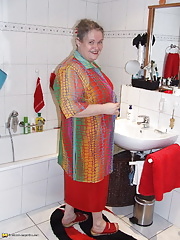 Big mama playing with whipped cream in the tub