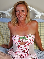 Blonde granny in white fishnet stockings stuffing and masturbating her pussy