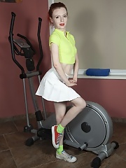 Brunette with red lips Eva Strawberry takes off her underwear to expose her pussy