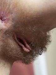 Brunette with red lips Eva Strawberry takes off her underwear to expose her pussy