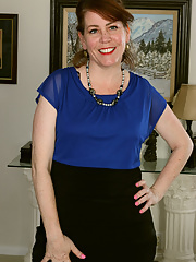 Elegant BBW mature Caitlin Moore spreads her legs wide open to show her pinkish stretched muff