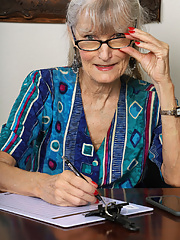 Old granny Linda Jones with sunglasses stripping off her clothes in the office