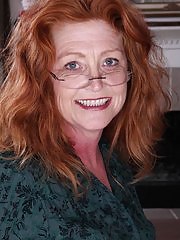 Older redhead Veronica Smith strips naked on the desk