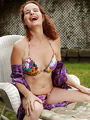 Redheaded Gloria M takes it all off and spreads outdoors