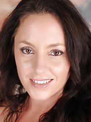 Curvy brunette MILF Tamara Fox bends over and touches her toes.