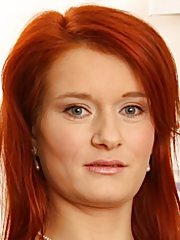 Seductive mature redhead Lucy Red posing naked in heels.