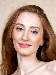 Lovely brunette Dadi Meow in red high heels takes off clothes and poses naked